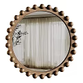 Round Wooden Mirror with Beaded Frame Reflecting White Curtains and Plant Branches