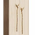 Elegant Golden Door Handles With Unique Curved Design On Light Wooden Cabinet Panels