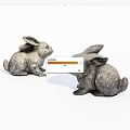 Two Gray Sitting Rabbit Dolls As Decorative Figurines On White Background