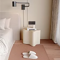 Modern Beige Bedside Table With Books And Decor On Wooden Floor In Bedroom