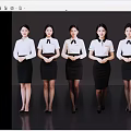 Women in Uniforms Standing Neatly with White Shirts Black Skirts on Dark Background