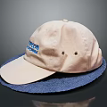 Beige Boston Cap With Blue Lettering Placed On Soft Blue Mat