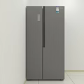 Modern Gray Double Door Refrigerator In White Room With Tiled Floor And Label