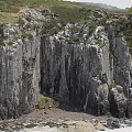 Scenic Coastal Cliff Landscape With Rugged Rock Formations And Green Vegetation