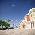 Vibrant Commercial Street With Colorful Buildings Street Lamp Woman Walking Blue Car And Blue Sky