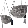 Woven Hanging Chair With Pink Cushion And Dark Blue Tassel Blanket