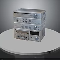 Stacked Electronic Audio Equipment With Knobs Buttons On White Round Platform