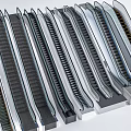 Various Modern Escalators With Different Designs And Metallic Finishes For Commercial Use