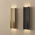 Modern Gold and Black Wall Lamps Illuminated Mounted on Light Colored Wall