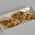Two Fresh Flaky Golden Croissants Served On White Rectangular Plate
