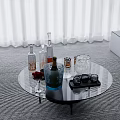 Stylish Wine Bottles And Glasses On Round Glass Table With Ice Bucket And Strawberries