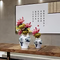 Blue and white porcelain vases with red yellow flowers on wooden table and calligraphy painting