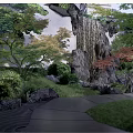 Rockery Stones With Waterfall And Pond In Traditional Garden Featuring Pavilion And Green Plants