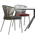 Round Outdoor Table With Metal Legs And Woven Rattan Chairs Red Black Cushions