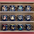 Blue Mugs with Various Zodiac Patterns on Three Tier Wooden Shelf