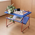 Blue Two Tier Side Table With Wheels Green Plant And Magazine On Top
