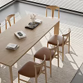Stylish Wooden Dining Table And Chairs Set With Leather Seats Books Vase And Natural Light
