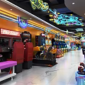 Colorful Playground Entertainment Area With Row Of Interactive Game Machines And Bright Lights