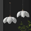 White Petal Shaped Pendant Lights With Golden Fixtures In Modern Interior With Green Plants