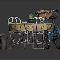 Outdoor Garden Table With Yellow Floral Tablecloth Chairs Plants Plates Blue Bicycle And Gardening Tools