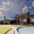 Modern Commercial Street Featuring Wooden Canopy Water Pool Green Lawn And Red Decorations