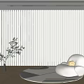 White Vertical Blinds In Modern Room With Accent Chair Potted Plant Beige Rug Floor Lamp