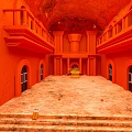 Red Interior With Arched Doors Stone Floor Stairs And Balconies