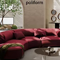 Curved Red Sofa with Cushions Round Coffee Table and Green Plant in Modern Living Room