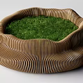 Circular Wooden Slatted Outdoor Chair Featuring Green Grass In The Center Design