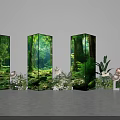 Floral Installation Featuring Three Forest Themed Display Pillars and Surrounding Flowers Green Plants