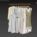 Women's Clothes Hanging on Hangers with Various Styles and Soft Beige Light Yellow Green Tones