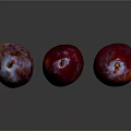Three Vibrant Red Purple Plums With Frosty Bloom On Dark Reflective Background