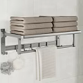 Bathroom Metal Towel Rack With Stacked Towels Hanging Towel And Bath Sponges