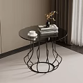 Round Glass Top Side Table with Black Metal Geometric Base Stacked Books and Vase