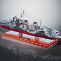 Vintage Warship Model with Turrets Chimneys and Flags on Red Wooden Base