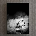 Black and White Female Figure Painting With Raised Arms Amidst Smoke and Decorative Details