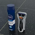 Essential Bathroom Accessories On Countertop With NIVEA Men Shaving Gel Razor And Holder
