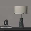 Modern Marble Base Table Lamp with Cream Lampshade on Table Beside Furniture Design Books