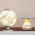 Globe And Mushroom Shaped Table Lamps On Wooden Table With Warm Illumination