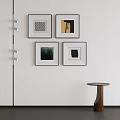 Four Abstract Paintings In Black Frames On White Wall With Wall Lamp And Small Table 3d model