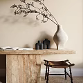 White Vase With Dried Flowers On Beige Marble Table Near Brown Stool And Open Books