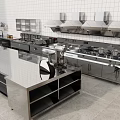 Commercial Kitchen Interior With Stainless Steel Worktables Range Hoods Sinks And Cabinets