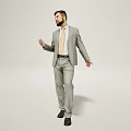 A Man In Gray Suit With Tie Standing Against White Background In Relaxed Pose