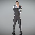 Man Wearing Black Tight Sportswear With White Accents Standing Arms Crossed On Gray Background