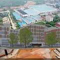 Aerial View of Modern School Campus Buildings With Green Rooftops Surrounding Roads and Sports Field