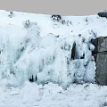 Garden Landscape With Thick Snow On Rocks And Cascading Ice Waterfall