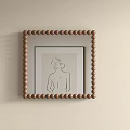 Mirror With Brown Beaded Frame And Simple Line Drawing Female Back Silhouette On Light Wall