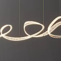 Contemporary Curved Chandelier Featuring Flowing Metallic Lines and Bright Illuminated Glow