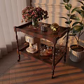 Classic Two Tiered Wooden Side Table With Floral Vase Yellow Figurine Coffee Machine And Glassware
