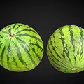 Two Fresh Watermelons With Green Striped Rind On Black Background